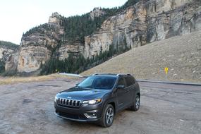 jeep on the road at the foot of the mountain