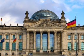 flags in front of facade of Reichstag, germany, berlin