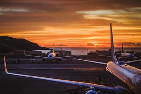 Planes in Airport on seaside at sunset