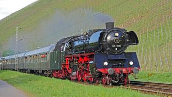 Br 03 steam locomotive near the beautiful, green hill in Saar Valley, Germany