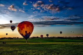 hot air balloons over a green rural landscape, usa, iowa