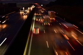 photo of night traffic on the road in the city