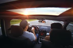 young man Driving Car on the road , view from inside