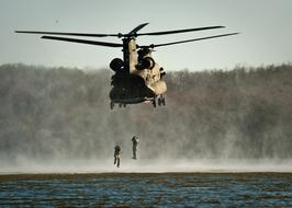 military jump from a helicopter into the water