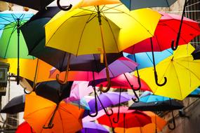 Colorful and beautiful, flying umbrellas in light