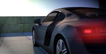 Back view of the black Audi R8 car with red lights