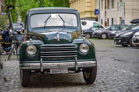 old italian car parked on city street