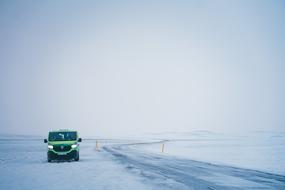 van vehicle on snowy road at Winter