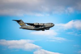 military transport aircraft C-17 flies in the sky