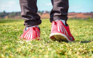 red shoes on feet on grass