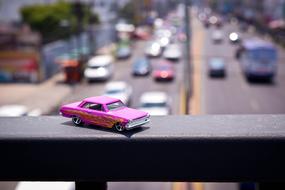 pink toy car on the bridge