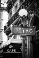 black and white photo of a metro sign in Paris