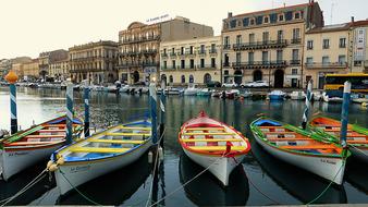 Colorful boats on the water near the buildings in France