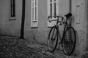 monochrome photo of a parked bicycle on a street in Prague