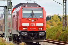 red locomotive train on the railroad