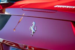 Ferrari horse logo on the hood of a red car