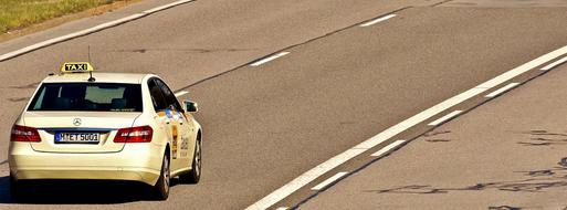 taxi, mercedes car is driving on the highway