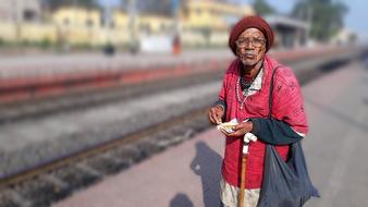 old man near the indian railroad at blurred background