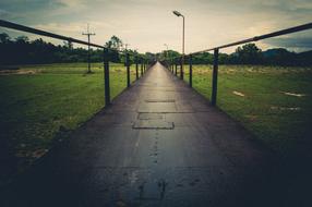 bridge over a green agricultural field