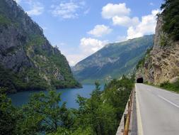 road near the lake near the mountain