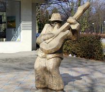 stone sculpture of a guitarist