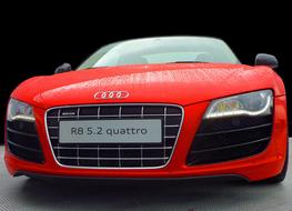 Front view of the red Audi Quattro sports cat in water drops