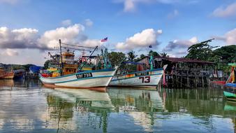 fishing boats at the village pier on the lake
