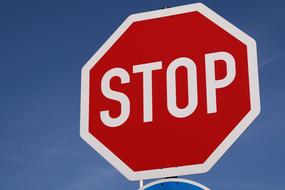 stop road sign on blue sky background