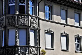 Beautiful building with the balconies on the corner in shadow and light