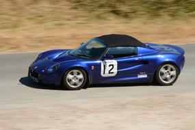 blue racing car with number 12 on the track