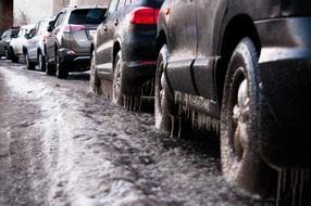 cars on a snowy road close up