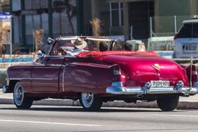 pink retro cadillac convertible on a street in Havana, Cuba