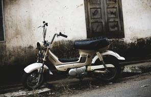 vespa scooter is parked in a dirt road