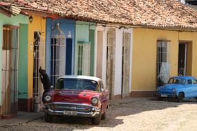 two old cars at picturesque building