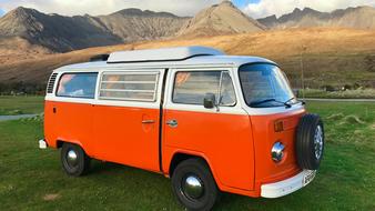 Combi Vw Van orange in the picturesque nature of scotland