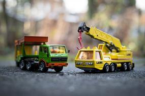 heavy machinery, two Toy Trucks