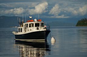 Colorful boat on the water under the white clouds in Washington