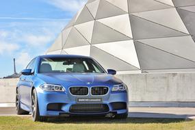 photo of a luxury blue bmw m5 car outdoors