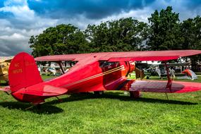 red Vintage Biplane on lawn