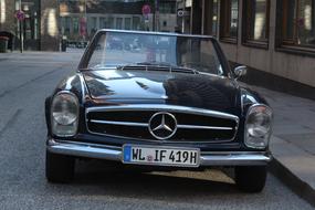 black retro cabriolet mercedes on the street