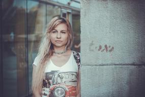photo of blonde at concrete wall