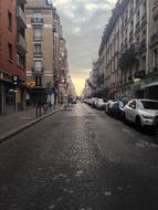 cloudy sky at sunset over city street