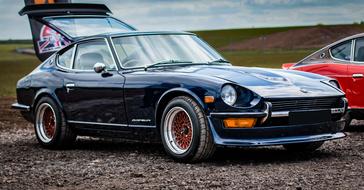 Blue Datsun 240Z car near the red car