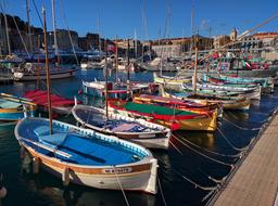 Old colorful boats moored at pier, france, nice