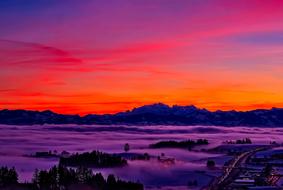 Beautiful landscape of Switzerland with the mountains with the trees, in the clouds, at colorful and beautiful sunset