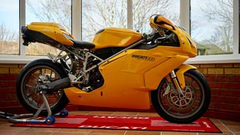 Model of the yellow "Ducati 999" bike, near the windows, with light
