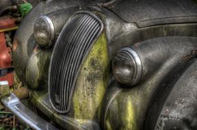 Colorful and beautiful, rusty, abandoned car with headlights