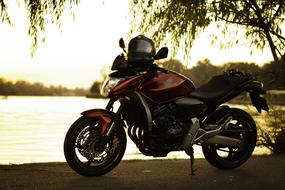 parked motorcycle on the lake at dusk