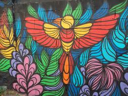 painted bird and flowers on the wall of a building in Paris