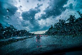 view through the windshield of the rain on the highway